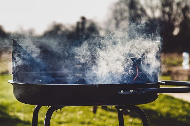 Smoke emanates from an outdoor grill